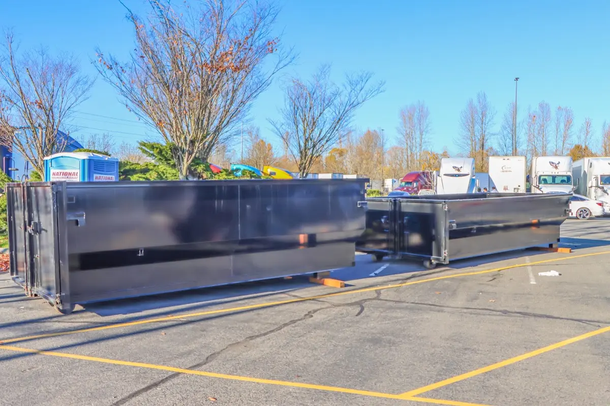 Professional dumpster rental service with roll-off container on residential driveway in Geneva